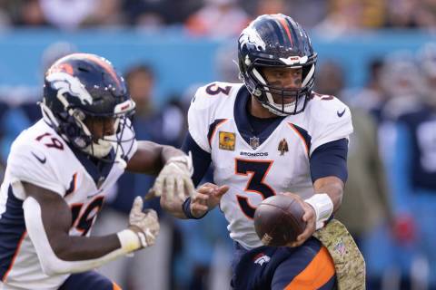Denver Broncos quarterback Russell Wilson (3) fakes a handoff to running back Chase Edmonds (19 ...