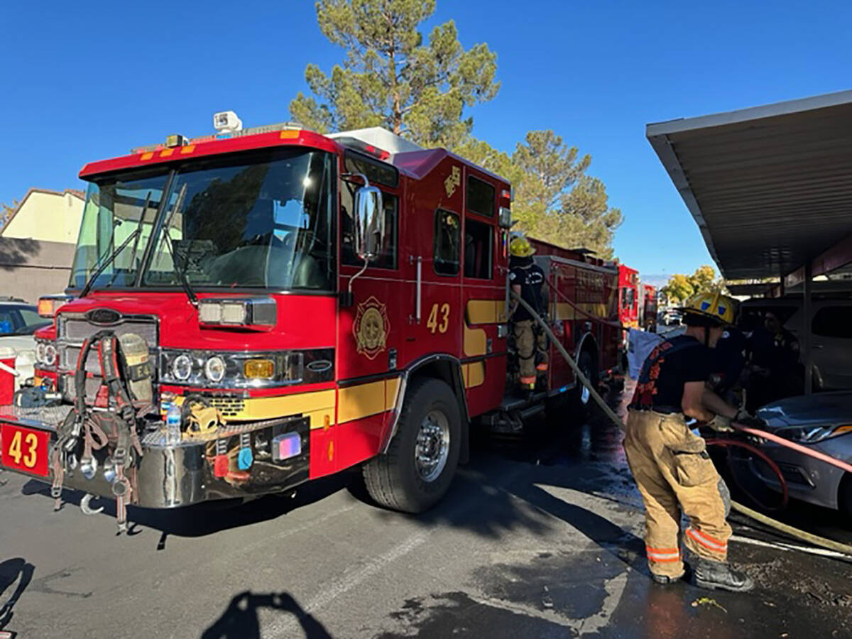Las Vegas firefighters recover their equipment after battling a two-alarm apartment fire Saturd ...