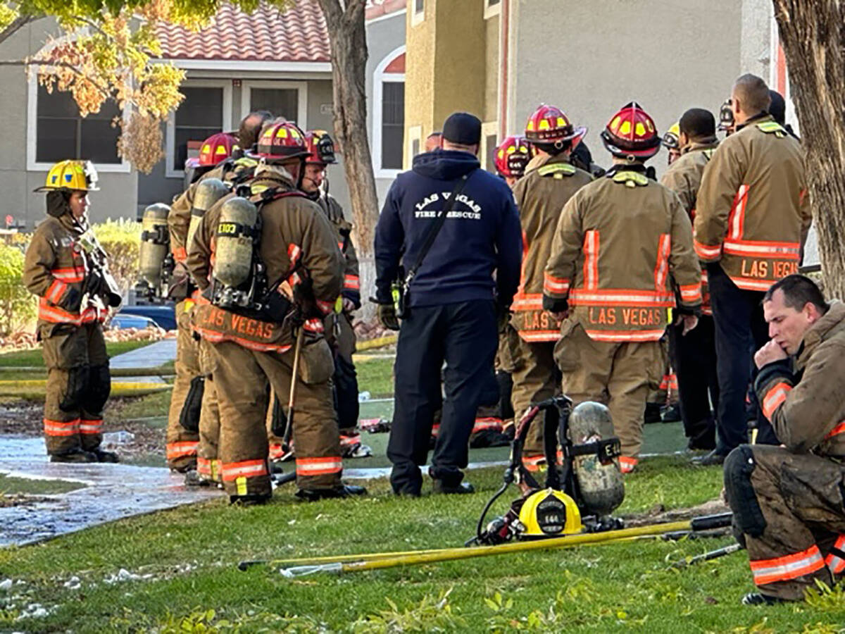 Las Vegas firefighters gather after battling a two-alarm apartment fire Saturday, Nov. 19, 2022 ...