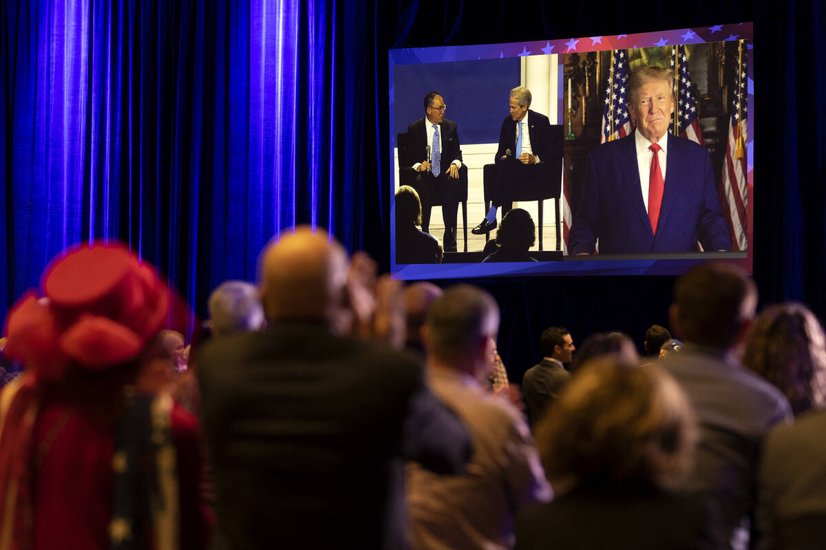 Former President Donald Trump, who appeared to speak on screen, receives a standing ovation fro ...
