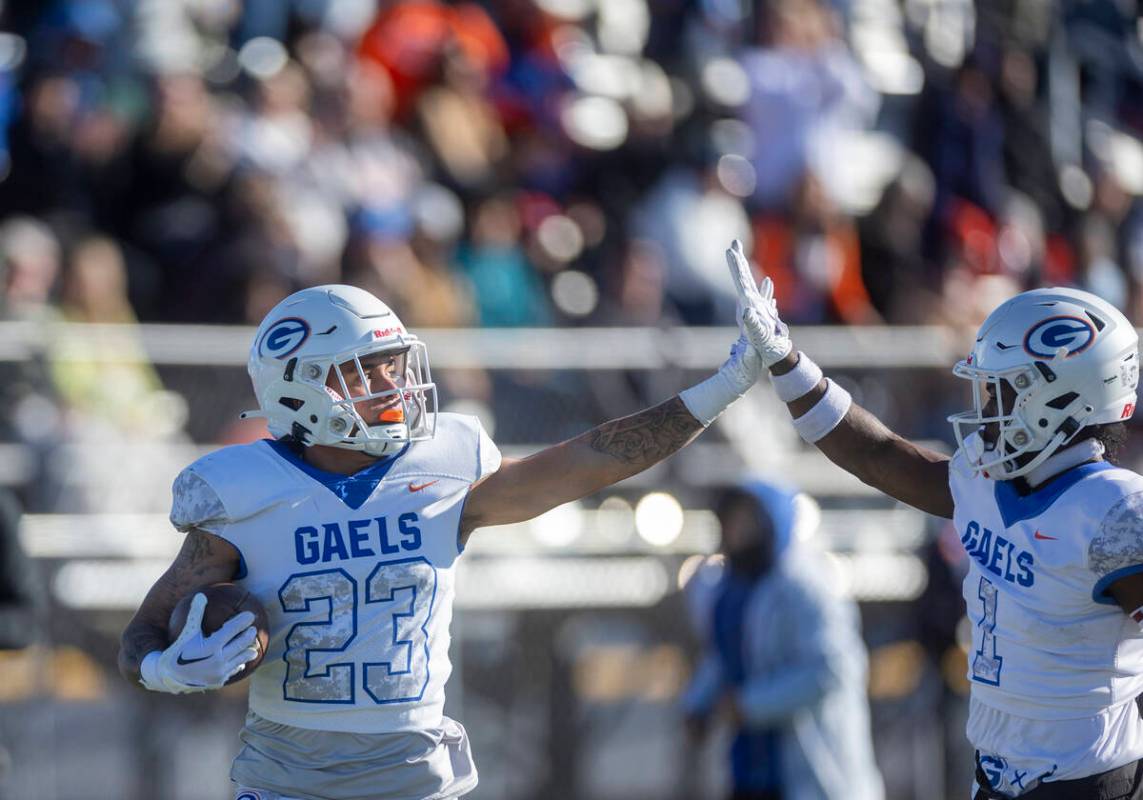 Bishop Gorman WR Trech Kekahuna (23) shares a "high five" with teammate WR Zachariah ...