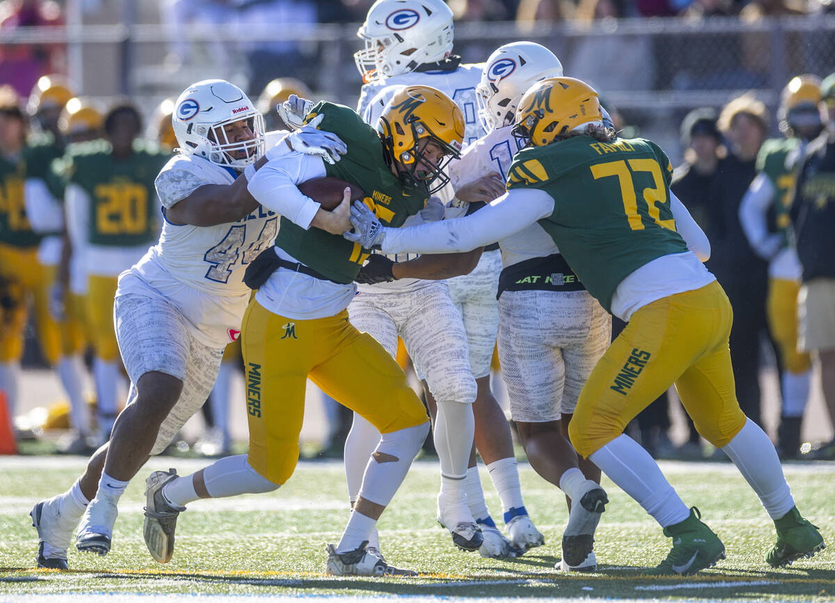 Bishop Gorman DL Aiden McComber (44) wraps up Bishop Manogue QB Logan Howren (15) for a sack du ...