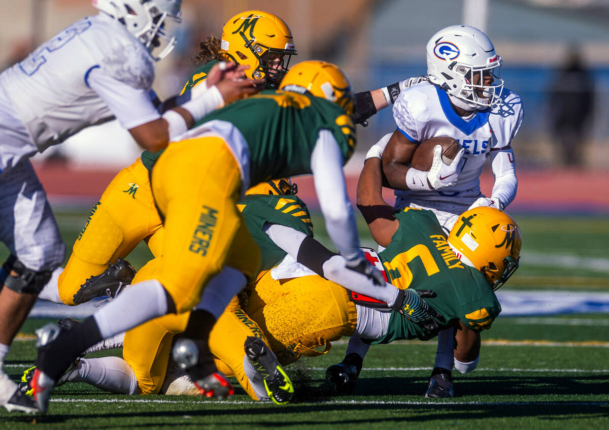 Bishop Gorman WR Zachariah Branch (1) avoids tackle attempts by Bishop Manogue DL Salesi Manu ( ...