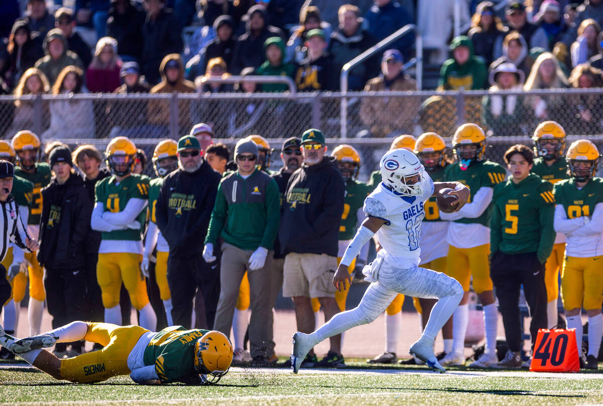 Bishop Manogue DB Carson Jensen (99) dives and misses Bishop Gorman QB Micah Alejado (12) runni ...