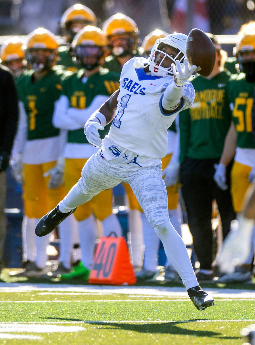 Bishop Gorman WR Zachariah Branch (1) extends for a reception attempt versus Bishop Manogue dur ...