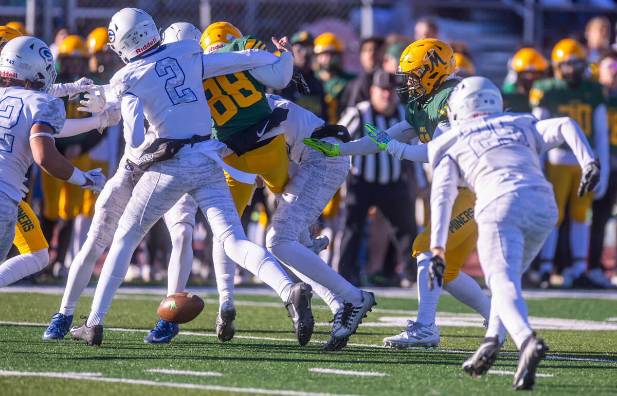 Bishop Manogue K Michael Rubino (88) has a kick blocked by Bishop Gorman defenders during the s ...