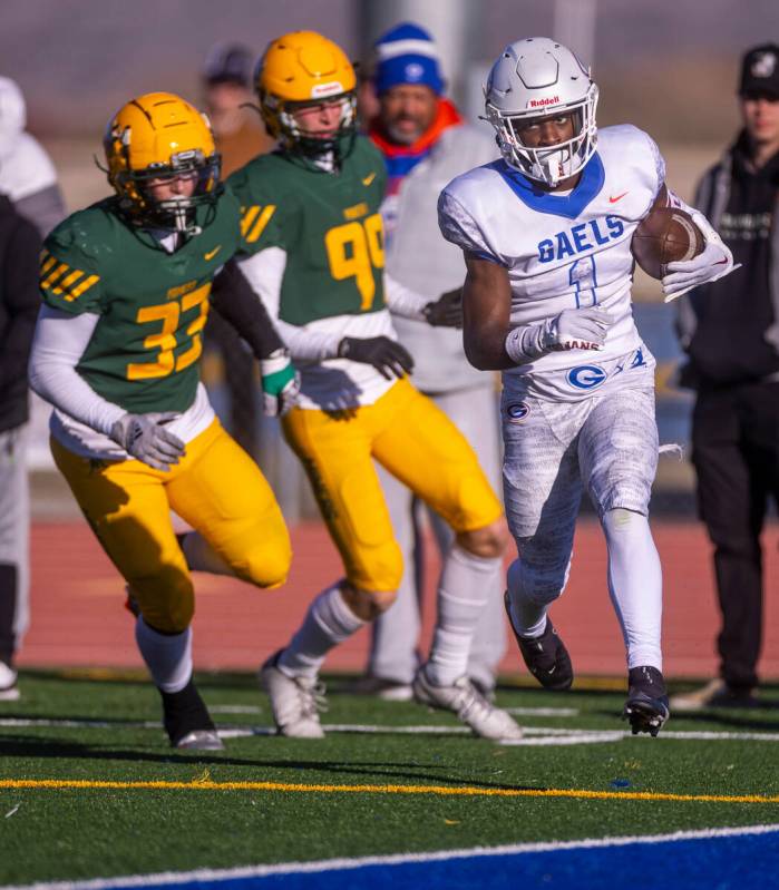 Bishop Gorman WR Zachariah Branch (1) beats Bishop Manogue LB Gio Granata (33) and DB Carson Je ...