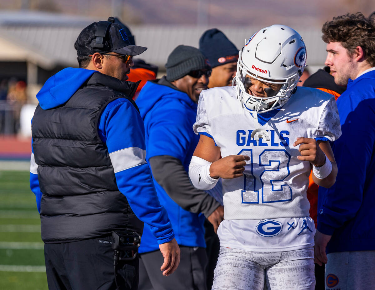 Bishop Gorman head coach Brent Browner looks to QB Micah Alejado (12) celebrating another touch ...