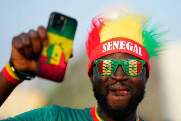 Fan of Senegal waits for the fan zone to open ahead of the FIFA World Cup in Doha, Qatar, Satur ...
