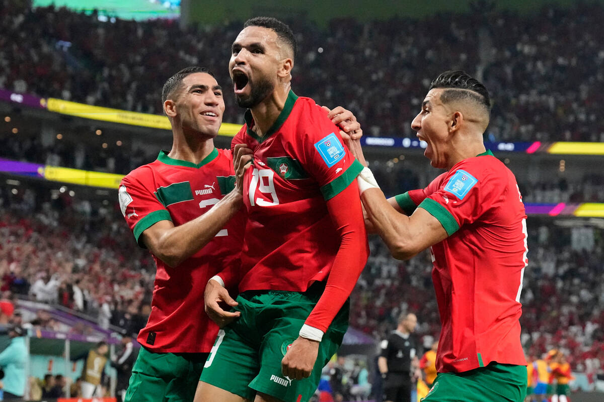 Morocco's Youssef En-Nesyri, center, celebrates after scoring his side's first goal during the ...