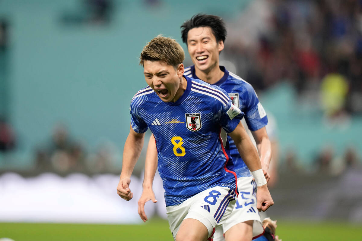 Japan's Ritsu Doan celebrates after scoring his side's opening goal during the World Cup group ...