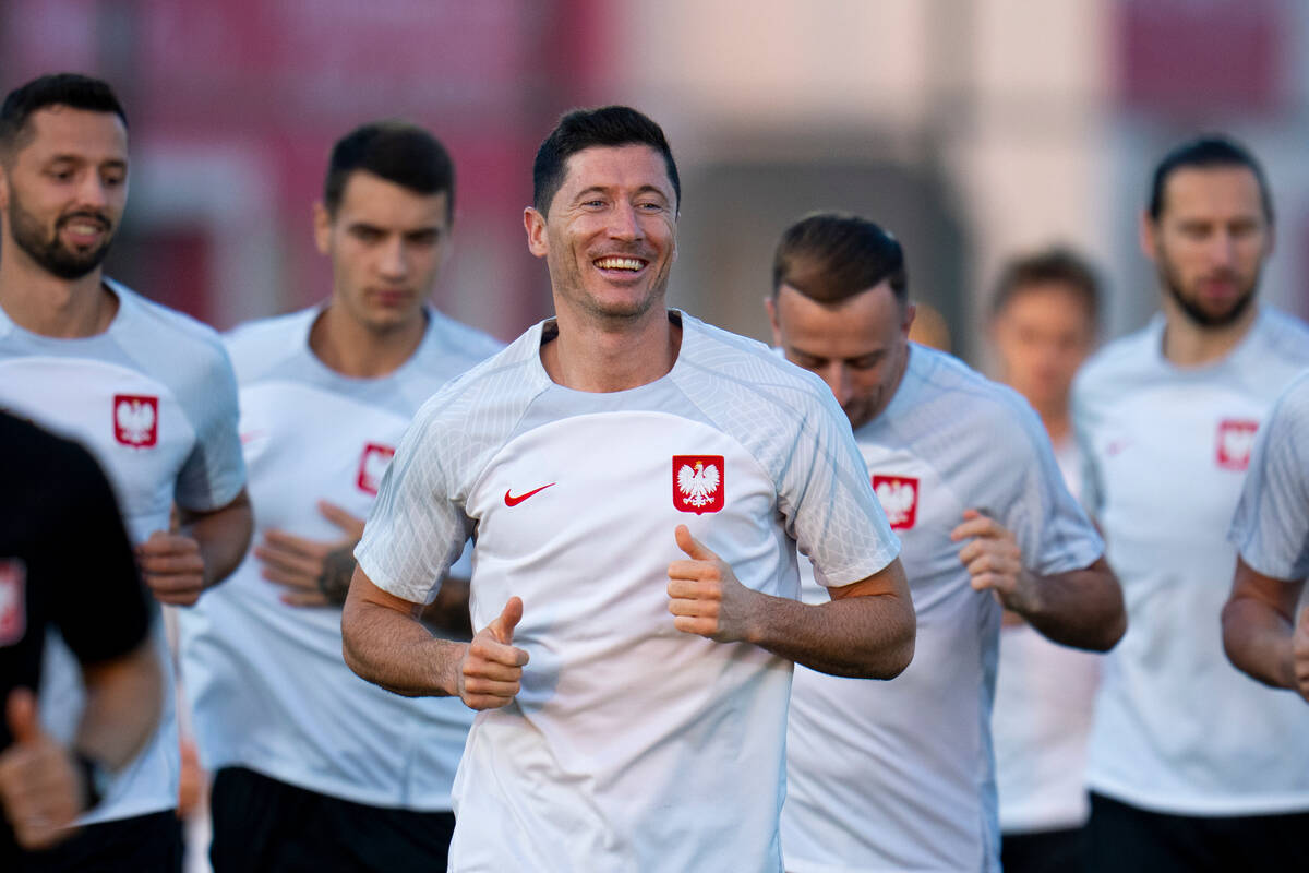 Poland's Robert Lewandowski, center, works out with teammates during a training session in Doha ...