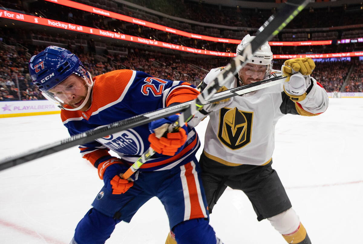 Vegas Golden Knights' Jonathan Marchessault (81) and Edmonton Oilers' Brett Kulak (27) compete ...