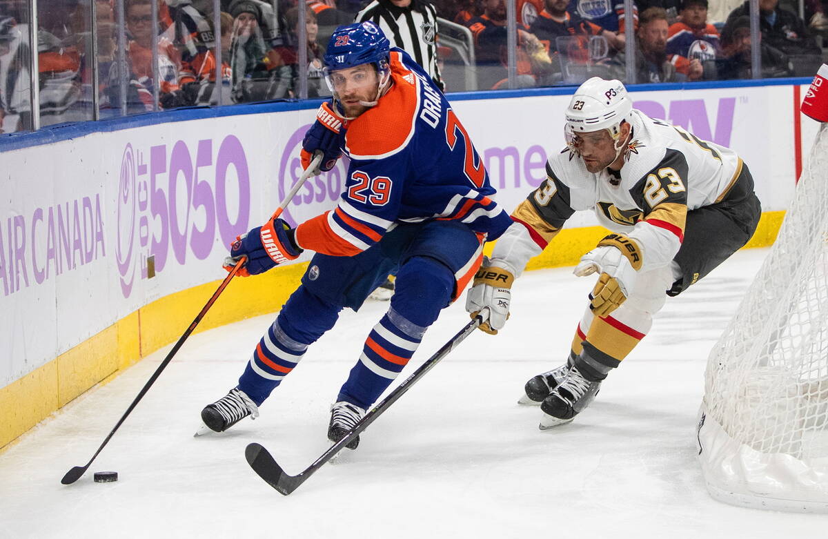Vegas Golden Knights' Alec Martinez (23) chases Edmonton Oilers' Leon Draisaitl (29) during the ...