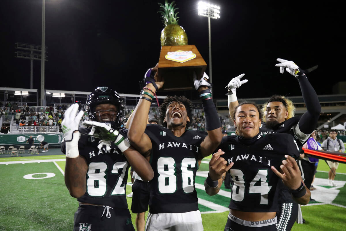 Hawaii wide receiver Alex Perry (82), place kicker Ben Falck (86), and wide receiver Chuuky Hin ...