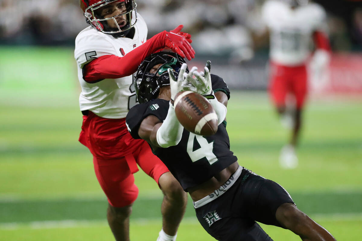 Hawaii wide receiver Jalen Walthall (4) can't pull in a catch while being guarded by UNLV defen ...