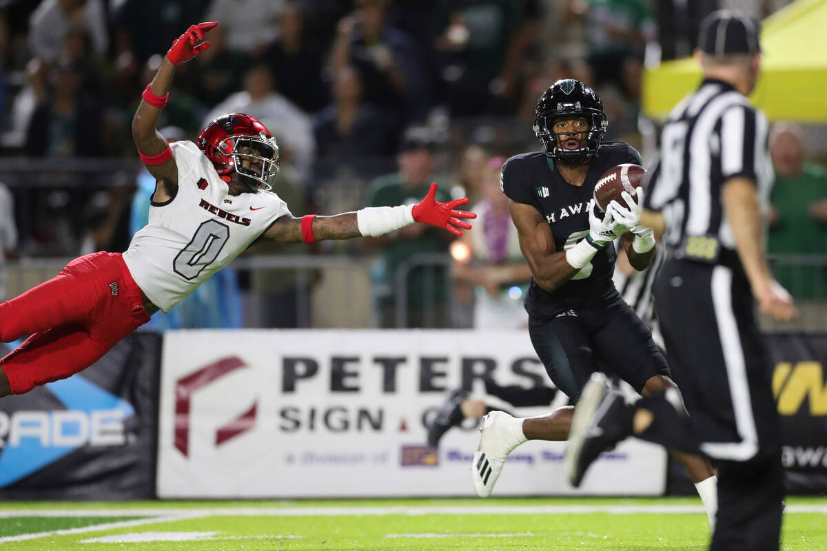 UNLV defensive back Ricky Johnson (0) can't stop Hawaii wide receiver Zion Bowens (6) from maki ...