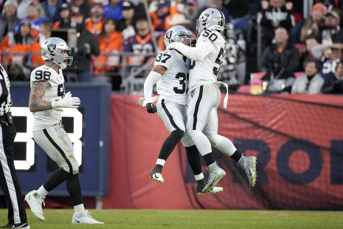 Las Vegas Raiders' Tyler Hall (37) is congratulated by linebacker Jayon Brown (50) and Maxx Cro ...
