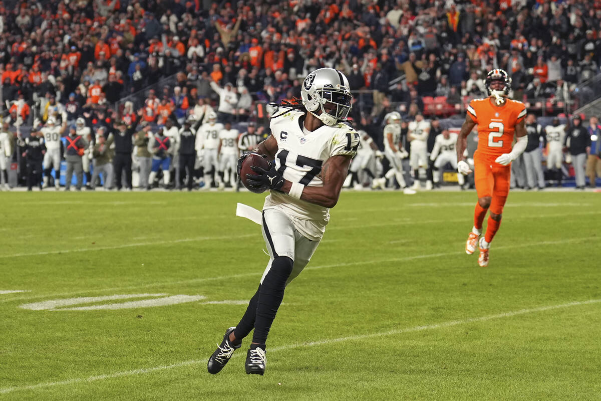 Las Vegas Raiders wide receiver Davante Adams (17) runs toward the end zone in front of Denver ...
