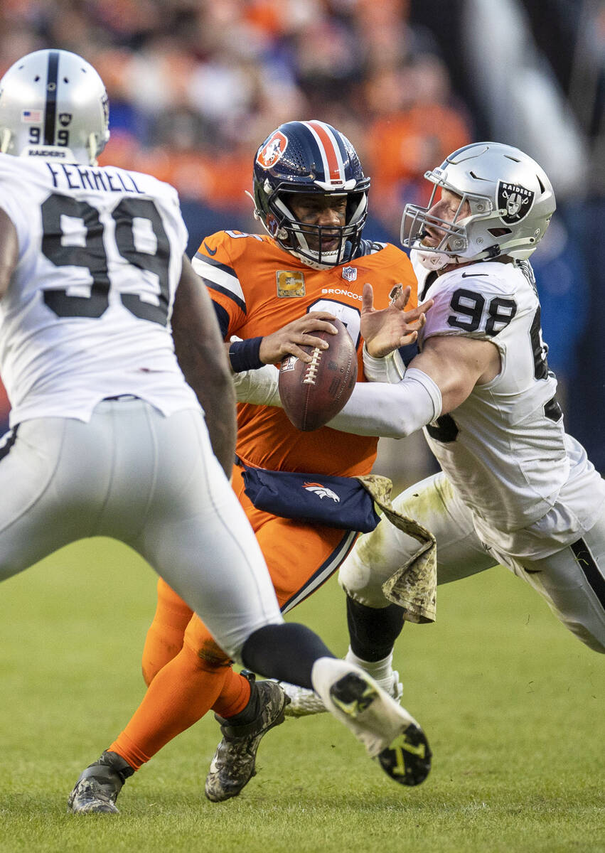 Raiders defensive end Maxx Crosby (98) sacks Denver Broncos quarterback Russell Wilson (3) duri ...