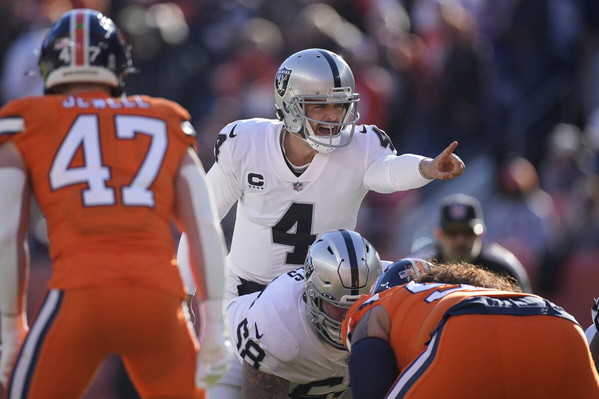 Las Vegas Raiders quarterback Derek Carr (4) signals at the line of scrimmage during the first ...