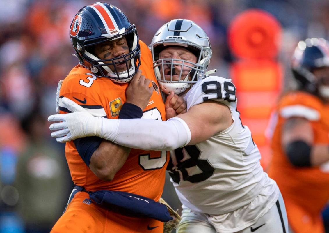 Raiders defensive end Maxx Crosby (98) pressures Denver Broncos quarterback Russell Wilson (3) ...