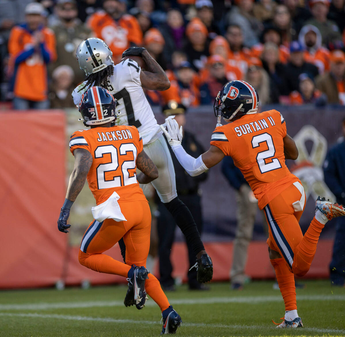 Raiders wide receiver Davante Adams (17) catches a touchdown pass over Denver Broncos safety Ka ...