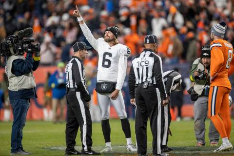 Raiders punter AJ Cole (6) signals that the team won the coin toss to start overtime during an ...