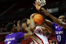 UNLV Rebels guard Luis Rodriguez (15) is pressured by High Point Panthers guard Bryant Randlema ...
