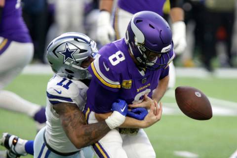 Minnesota Vikings quarterback Kirk Cousins (8) fumbles as he is tackled by Dallas Cowboys lineb ...