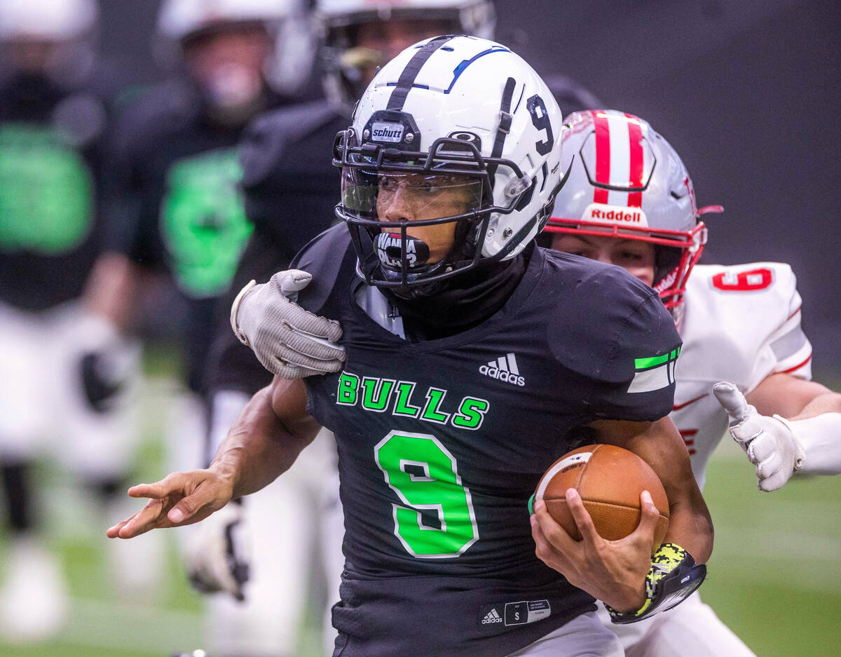 SLAM Academy QB Donnell Colbert (9) looks for more yards on a run with Truckee MLB Max Ellermey ...