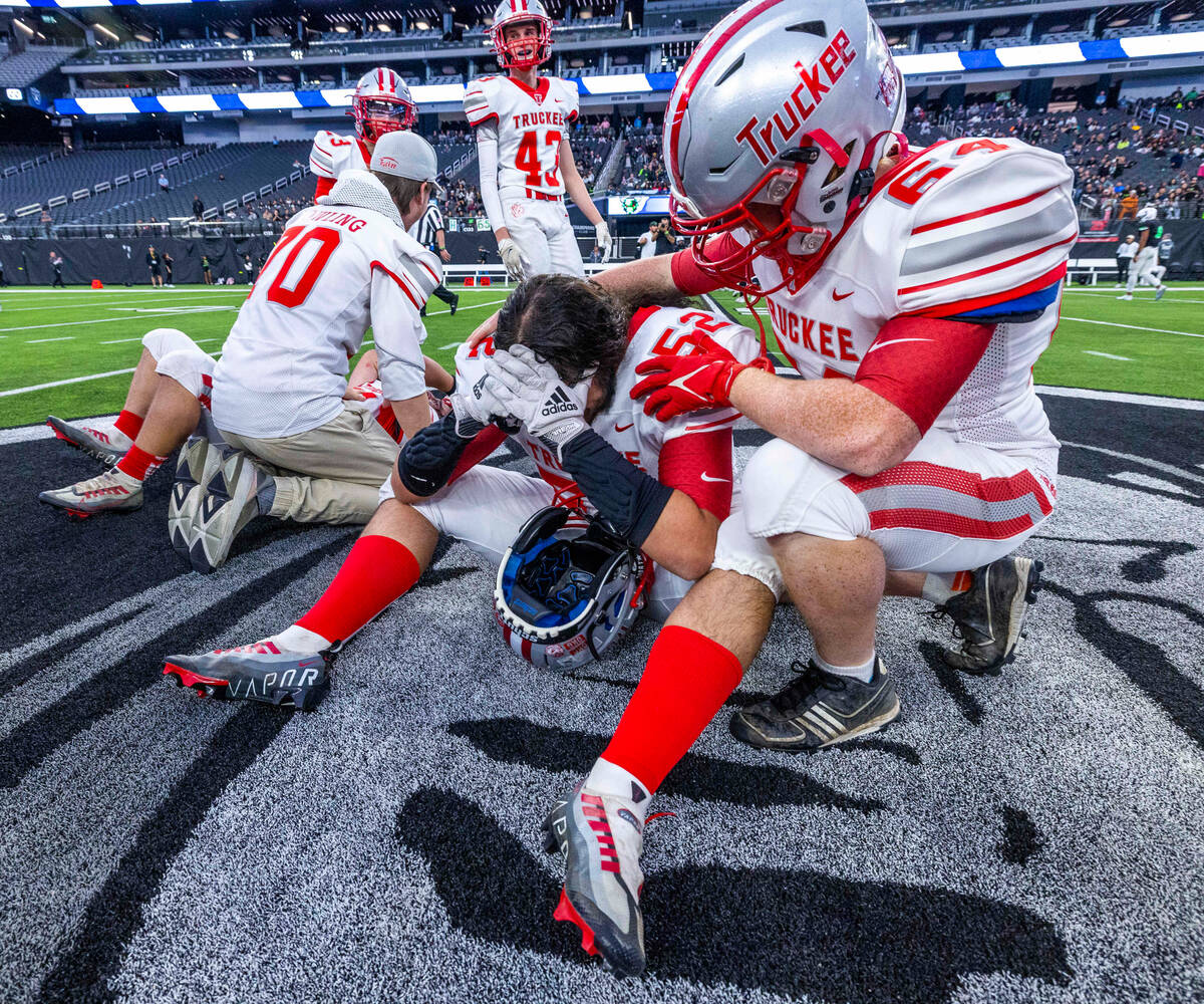 Truckee DE Joaquin Avila (52) weeps for joy as teammate C True Laboissonniere (64) comforts him ...