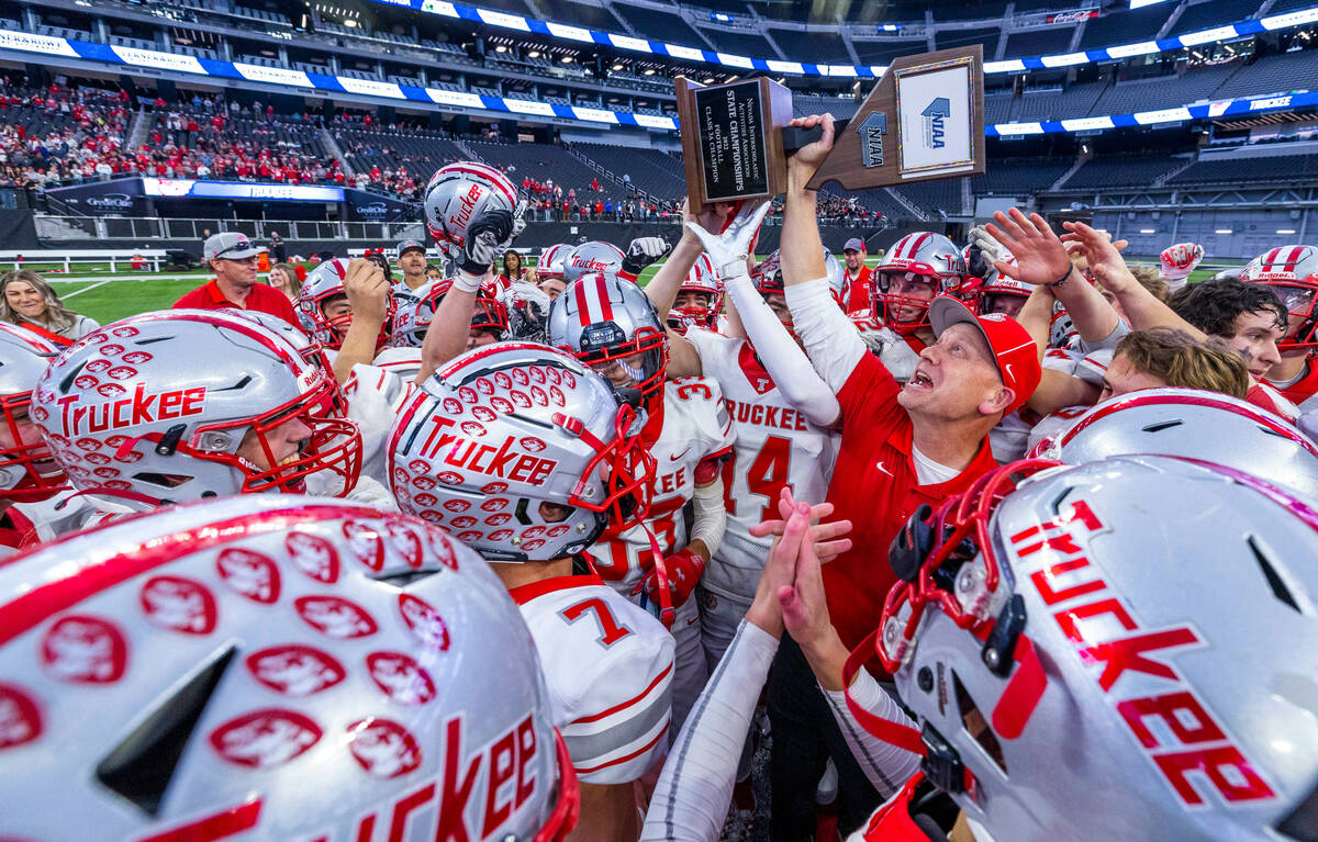 Truckee Head Coach Josh Ivens celebrates the winning trophy with his team defeating SLAM Academ ...