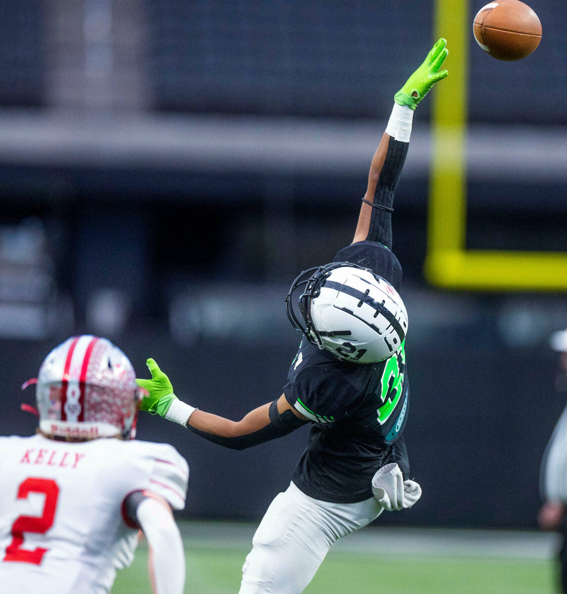 SLAM Academy WR Chysten Tabangcura (21) extends for a reception attempt with Truckee FS Miles K ...