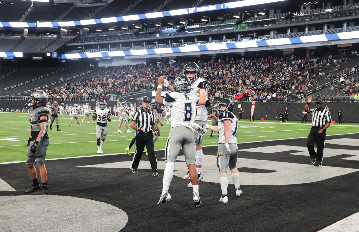 Shadow Ridge's quarterback Coen Coloma (8) celebrates his touchdown with Liam Guthrie (14) duri ...
