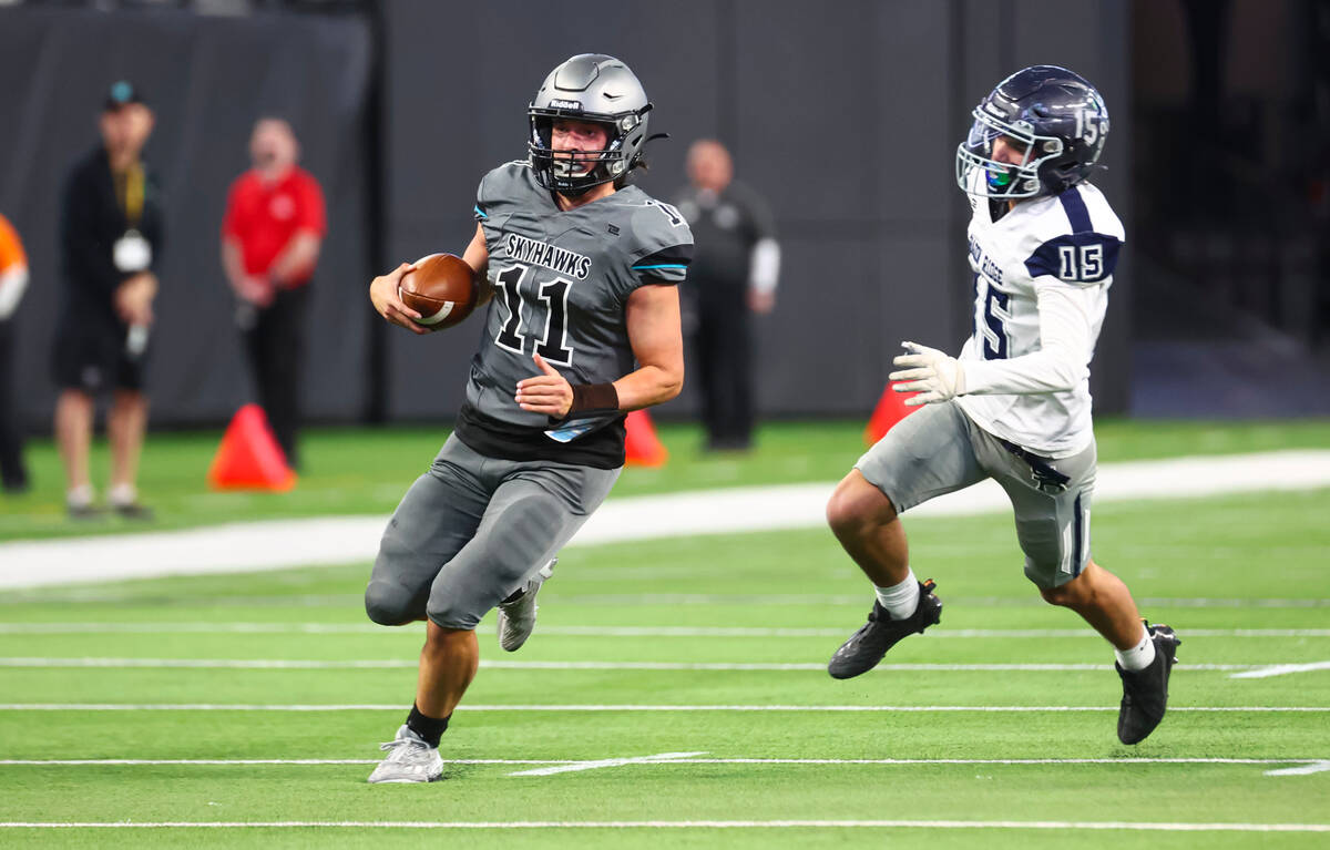 Silverado's Brandon Tunnell (11) runs the ball ahead of Shadow Ridge's Diego Faulkner (15) duri ...