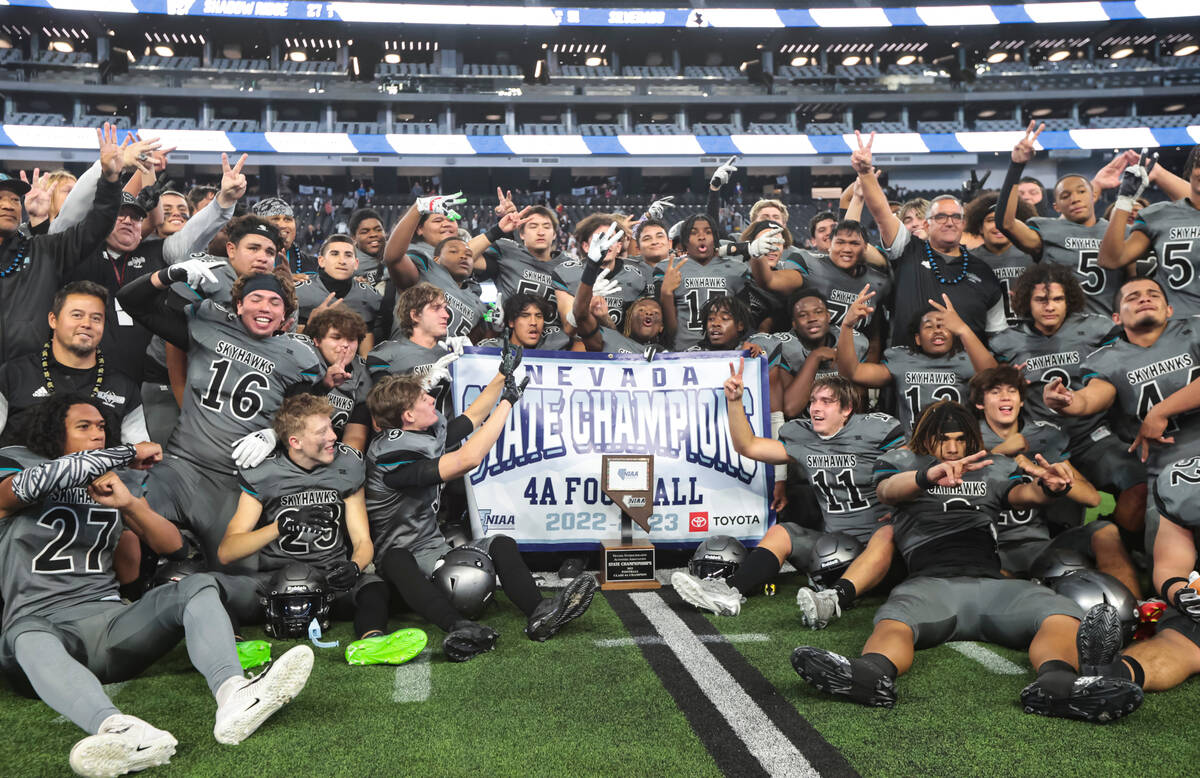 Silverado players pose with the trophy after defeating Shadow Ridge to win the Class 4A footbal ...