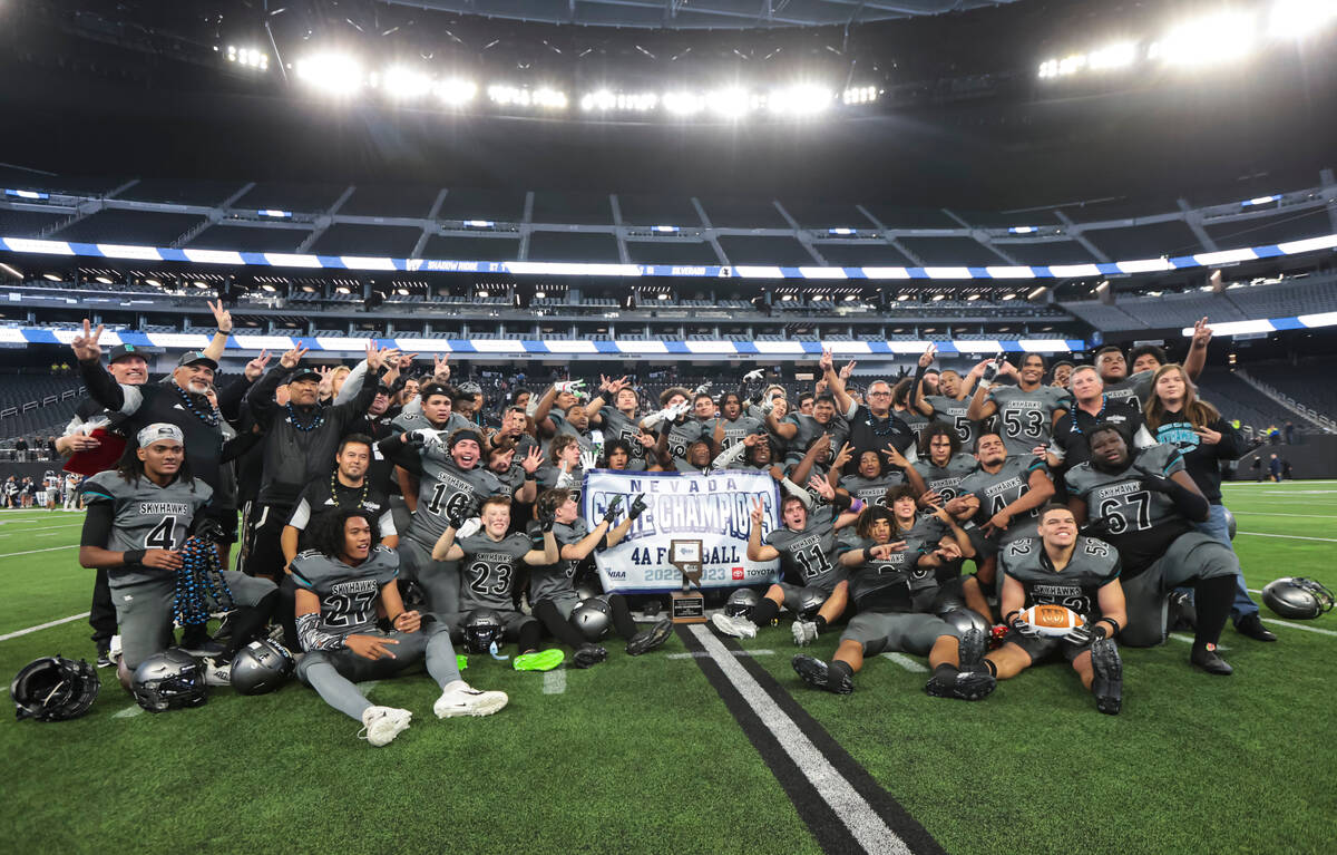 Silverado players pose with the trophy after defeating Shadow Ridge to win the Class 4A footbal ...