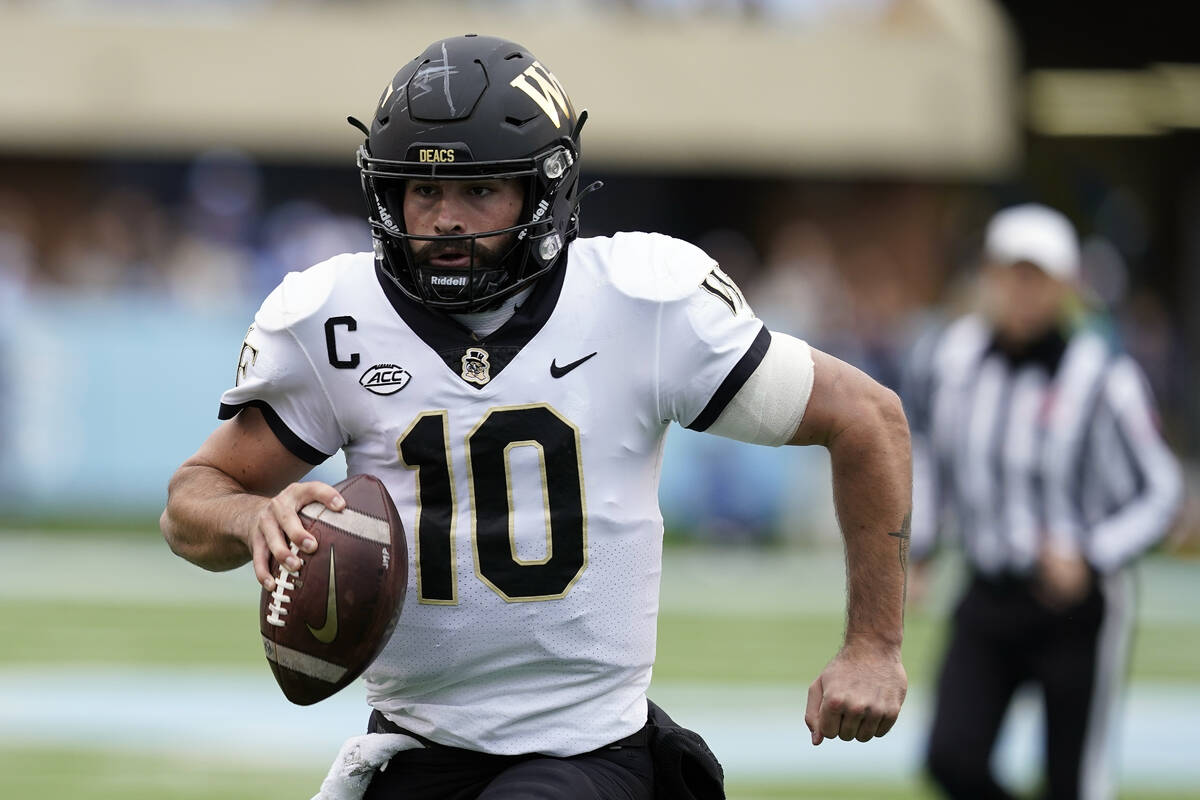 Wake Forest quarterback Sam Hartman (10) runs for a touchdown against North Carolina during the ...