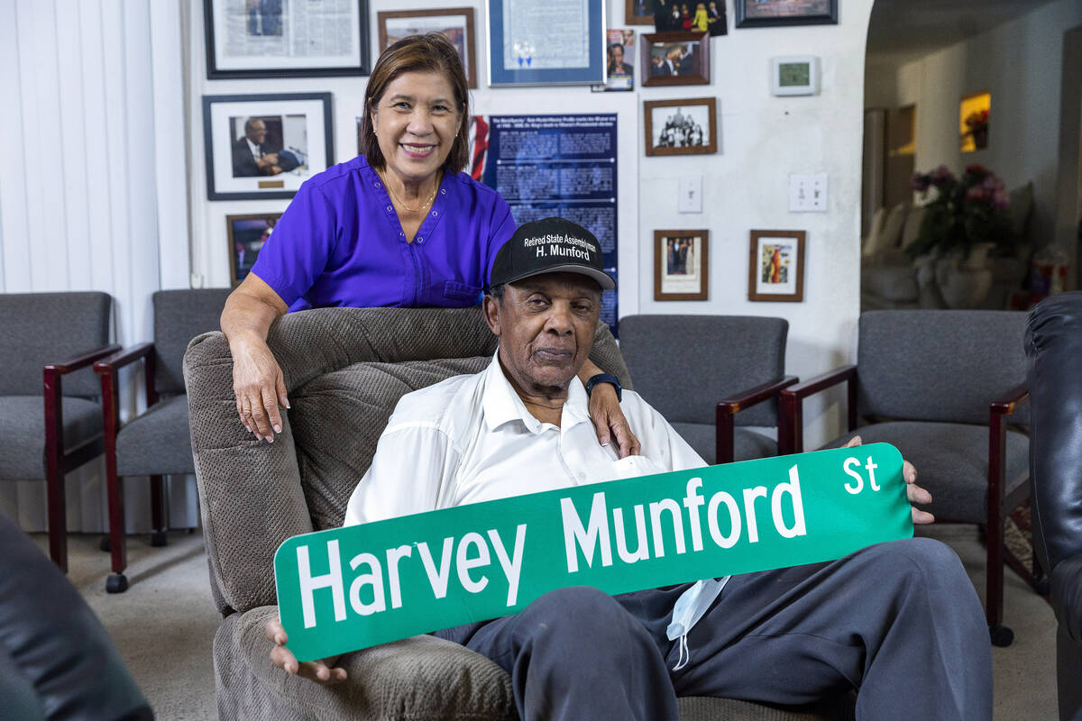 Harvey Munford with his wife Vivian relaxes at home showing off a mock up of his new street sig ...
