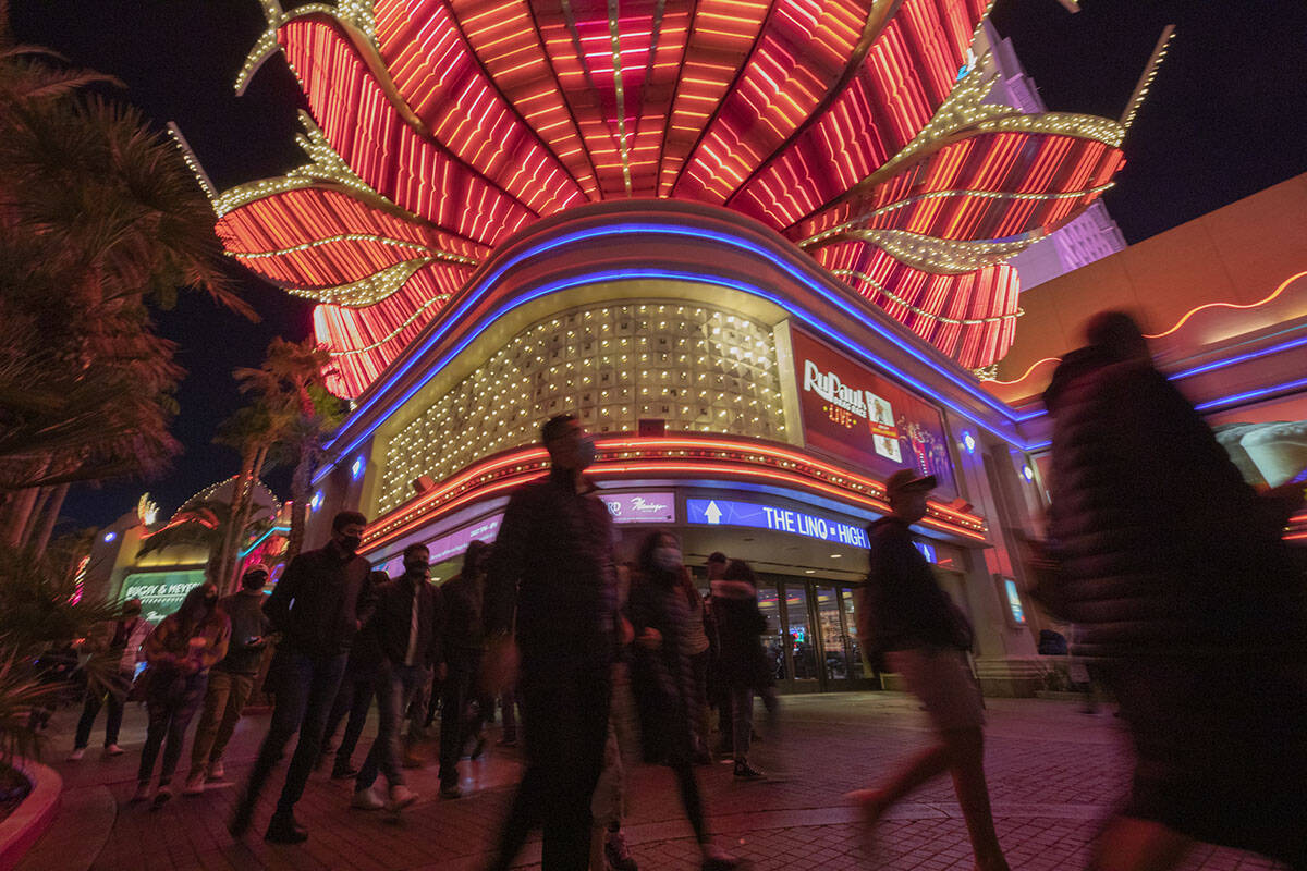 Tourists walk near the Flamingo casino-hotel on the Las Vegas Strip on Friday, Nov. 27, 2020, i ...