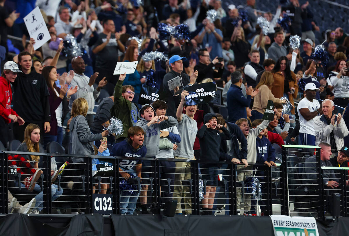 Supporters of The Meadows cheer after a touchdown against Lincoln County during the first half ...