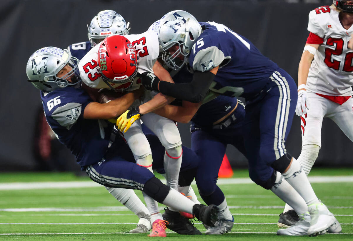 The Meadows' Billy Jennings (66) and Robert Stamanis (75) tackle Lincoln County's Ryan Hannig ( ...