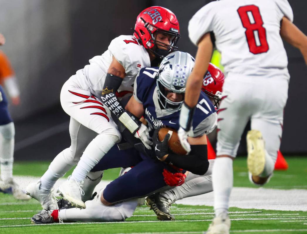 The Meadows' Aiden Otano (17) gets tackled by Lincoln County's Marc Mcclain (7) during the firs ...