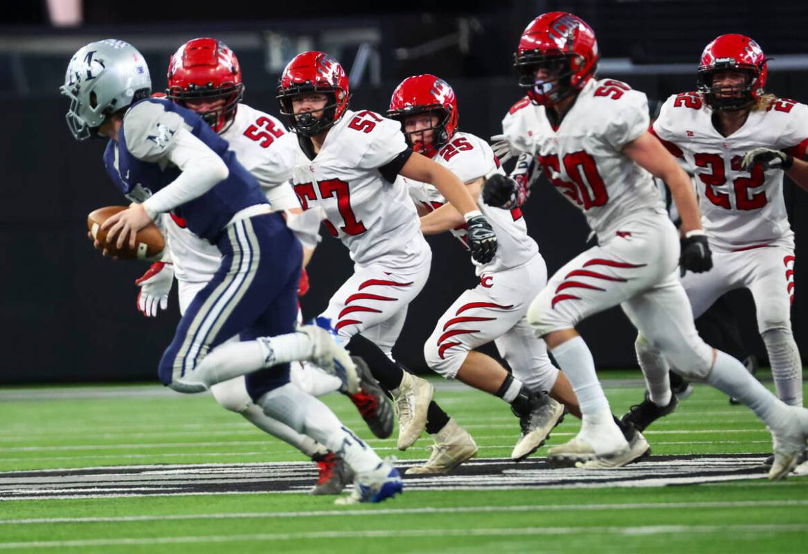 Lincoln County defenders chase after The Meadows quarterback Sean Gosse (7) during the first ha ...