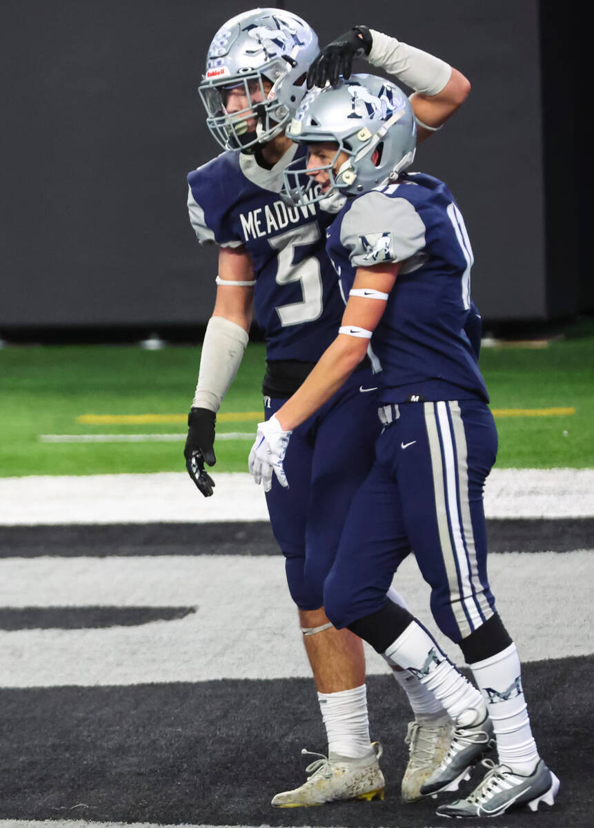 The Meadows' Evan Baalbaky (5) celebrates his touchdown with The Meadows' Finnegan Riley (11) d ...
