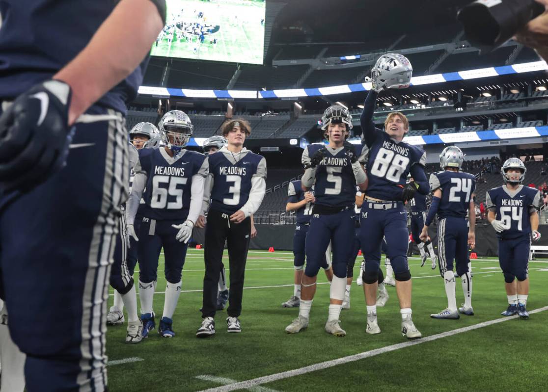 The Meadows players celebrate after defeating Lincoln County to win the Class 2A football state ...