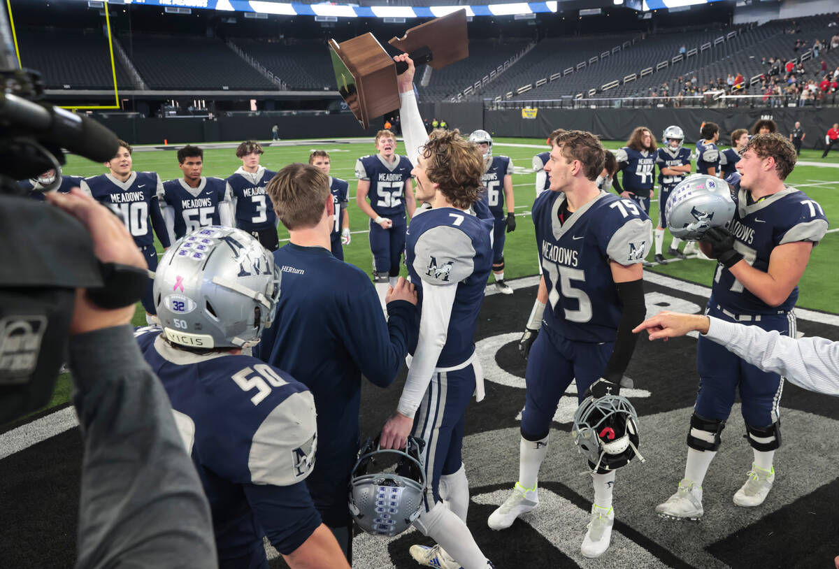 The Meadows' Sean Gosse (7) raises the trophy to celebrate after defeating Lincoln County to wi ...