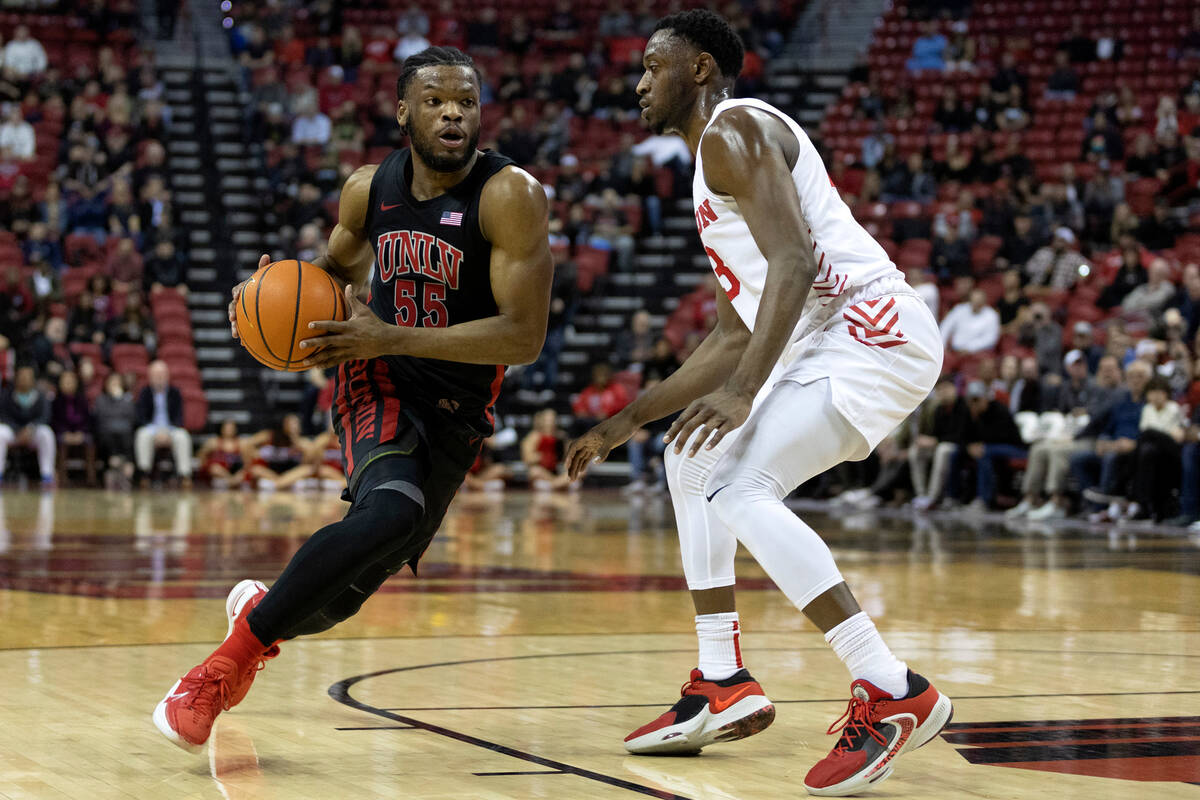 UNLV Rebels guard EJ Harkless (55) drives around Dayton Flyers forward R.J. Blakney (23) during ...