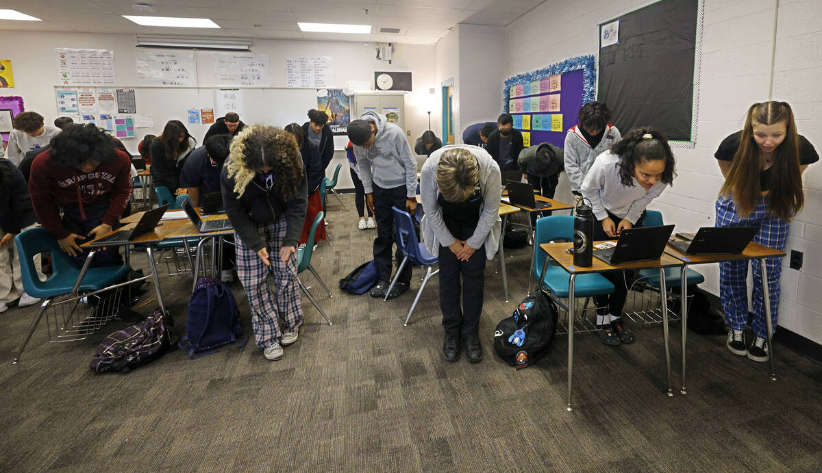 Silverado High School Japanese language teacher Kathryn Breshears, center, bows with her studen ...